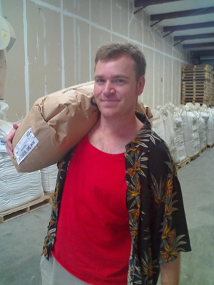 Chris carries a bag of two-row pale malt.